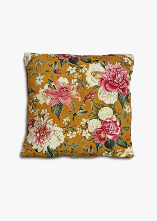 Funda de coixí de tela de cotó amb disseny floral sobre fons ocre